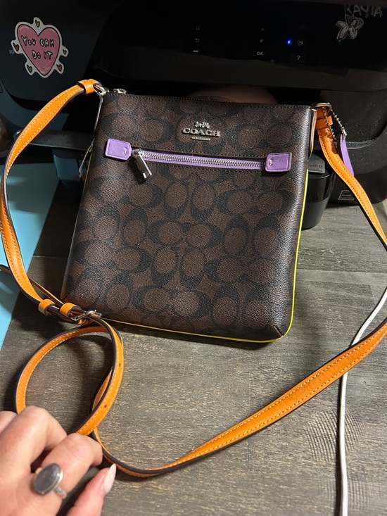 Coach Handbags - Coach Mini Rowan File Bag in Colorblock Signature Canvas.
Purple Orange Yellow